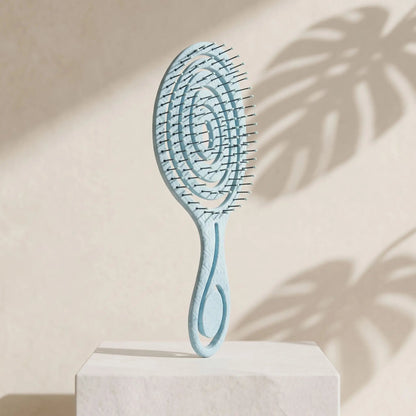 Brosse_cheveux_boucles_et_lisses_demelage_magique_en_spirale_couleur_bleu_ciel_pastel.
